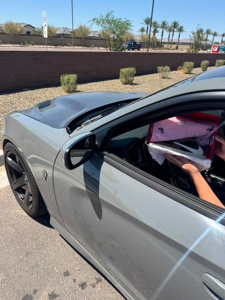 Customer receiving Travis Scott style Air Jordan 1 Low in car on delivery day