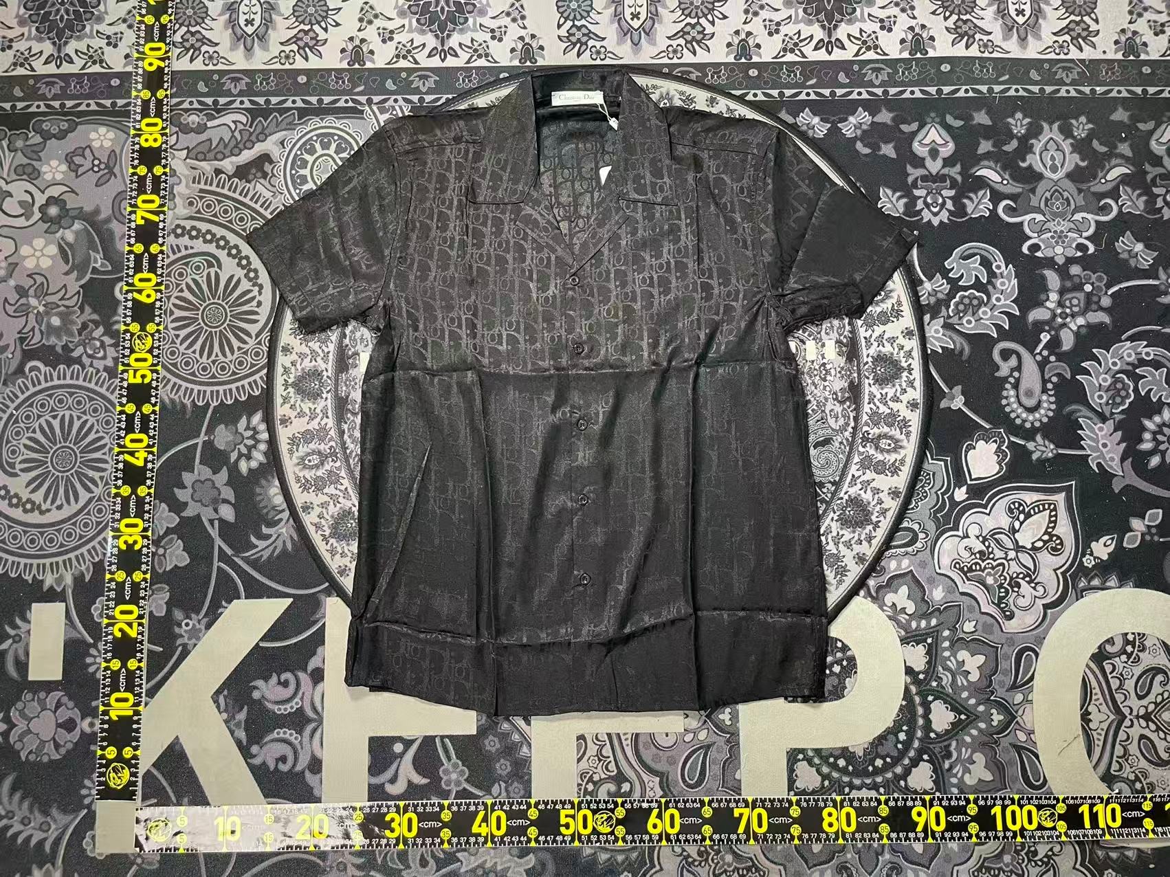 Dior Black Oblique Button-Up Shirt — QC inspection with Christian Dior hang tag, silk-like sheen visible