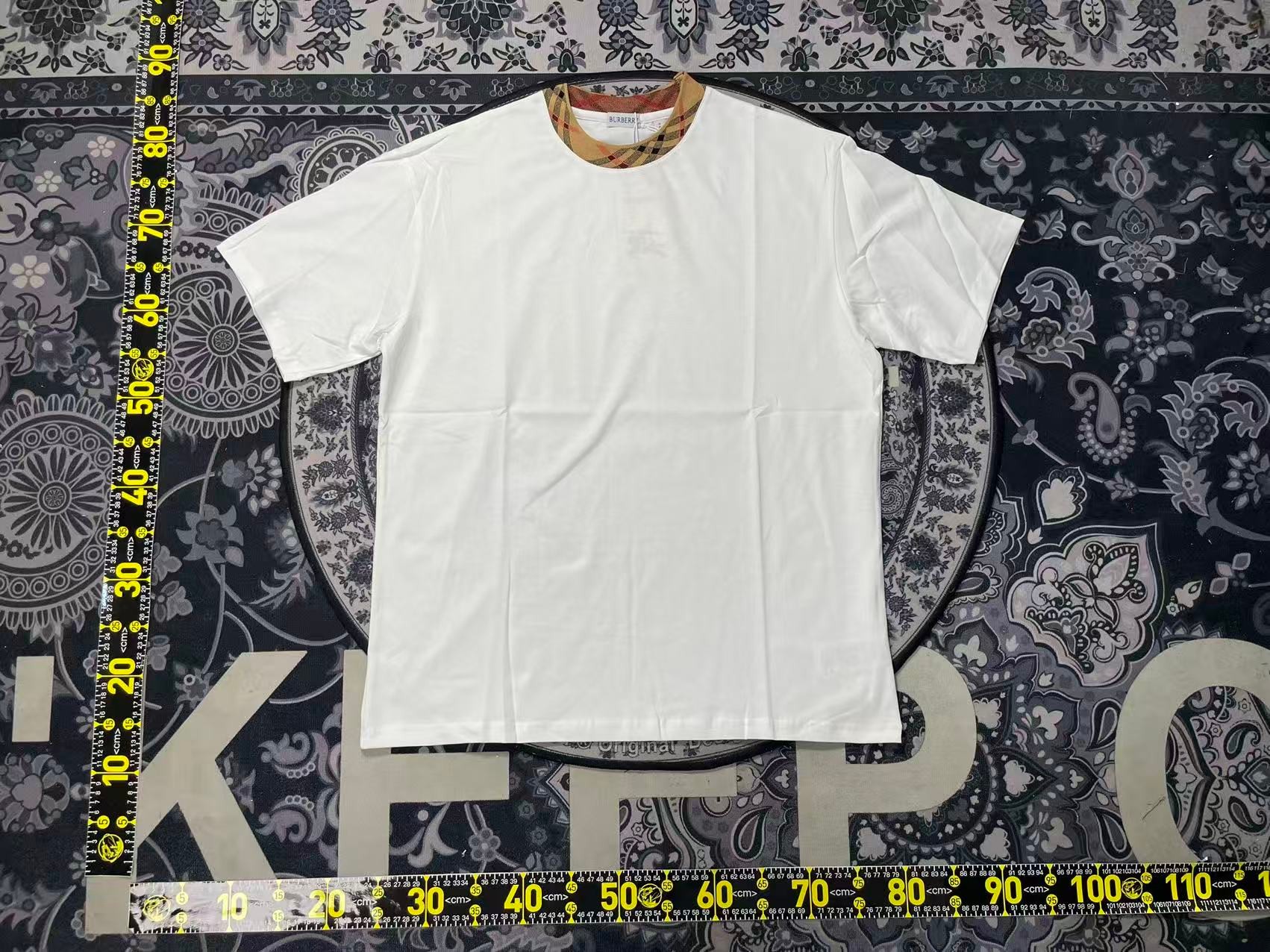 Burberry White Tee — classic check trim on the collar, flat measurement on the mat