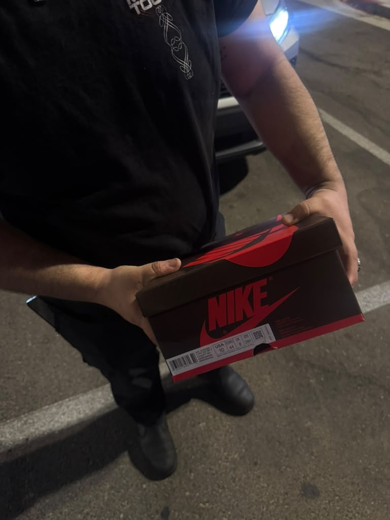 Night-time customer unboxing of delivered Nike pair