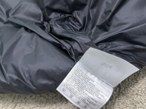 Ate Crop 90Down cropped puffer jacket — care label