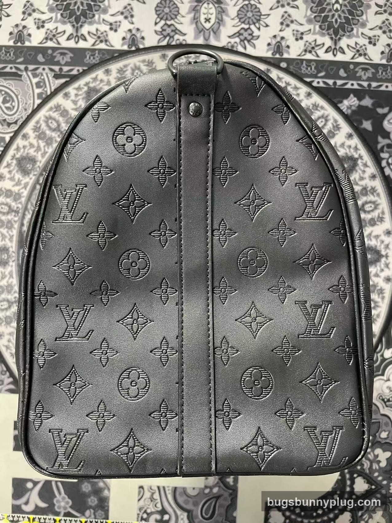 L&V monogram backpack QC photo, embossed monogram and top handle